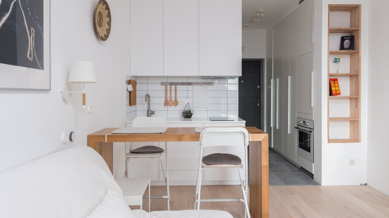 A cozy minimalist apartment interior with modern kitchen and living space.